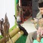 Kai Umpok menyusun wayang kulit di atas panggung sebelum tampil